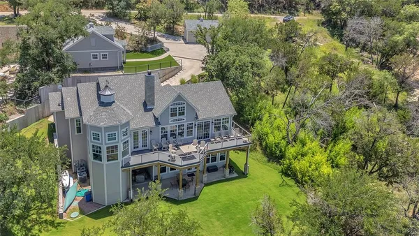 an aerial view of a house with swimming pool and big yard