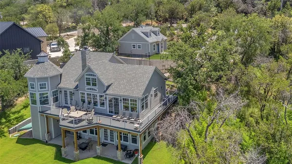 an aerial view of a house with a yard