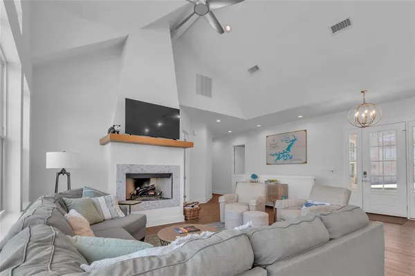 a living room with furniture a fireplace and a flat screen tv