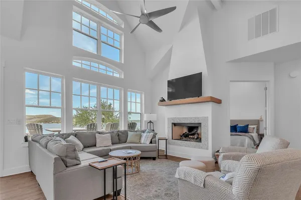 a living room with furniture fireplace and flat screen tv