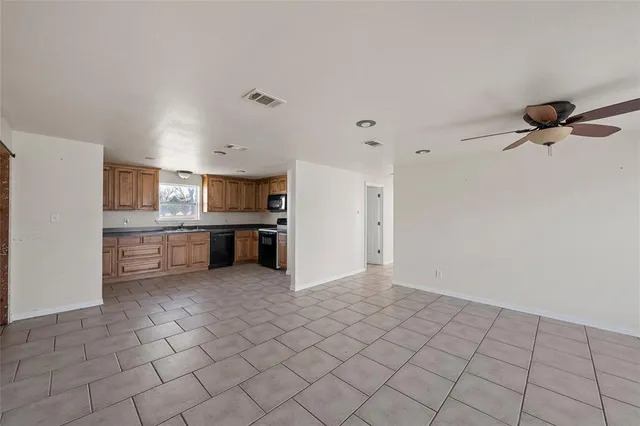 a view of kitchen with a sink cabinets and window