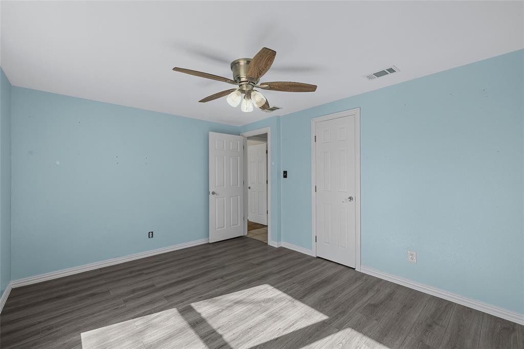310 3rd Street Abbott, TX 76621 - Photo 12 of 23 a view of a room with wooden floor and a ceiling fan