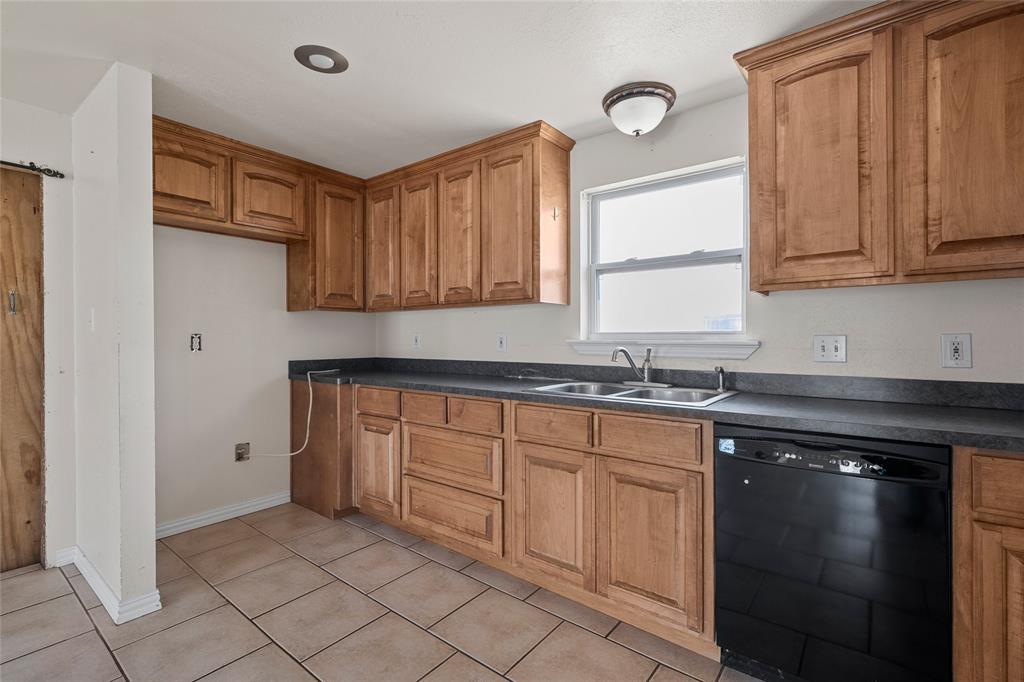 310 3rd Street Abbott, TX 76621 - Photo 6 of 23 a kitchen with granite countertop white cabinets and a sink