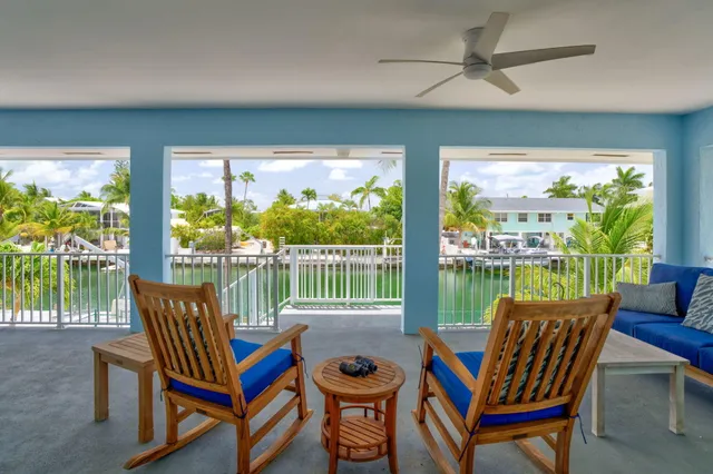 a balcony with furniture and a potted plant