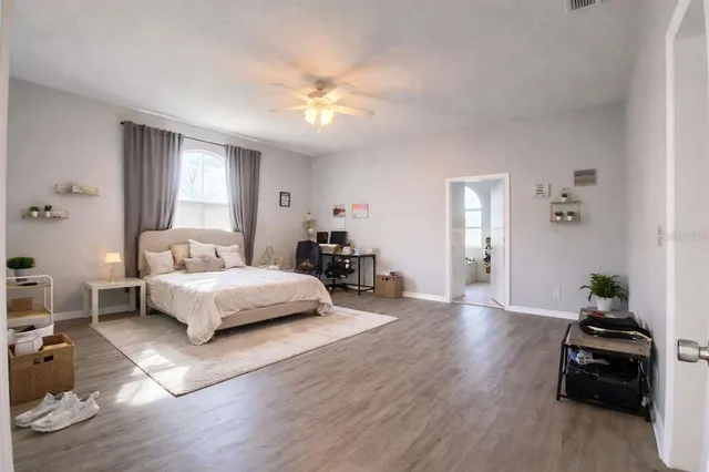 a bedroom with a bed and a chandelier