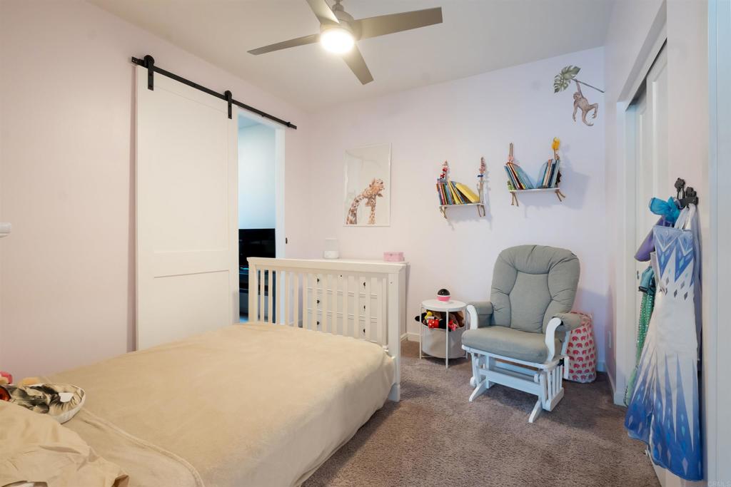 522 South Cleveland Street, Unit 7 Oceanside, CA 92054 - Photo 11 of 24 a bedroom with a bed and a chandelier