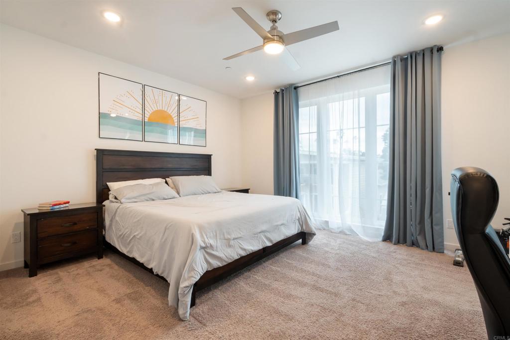 522 South Cleveland Street, Unit 7 Oceanside, CA 92054 - Photo 17 of 24 a large bed sitting in a room next to a window