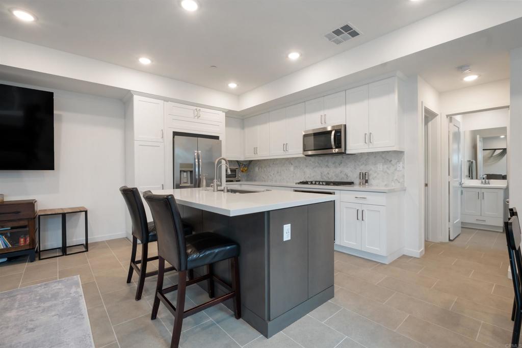 522 South Cleveland Street, Unit 7 Oceanside, CA 92054 - Photo 21 of 24 a kitchen with a sink a microwave and cabinets