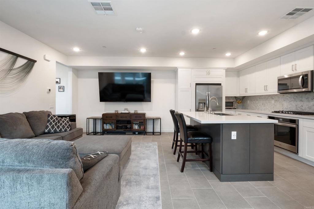 522 South Cleveland Street, Unit 7 Oceanside, CA 92054 - Photo 7 of 24 a living room with furniture and a flat screen tv