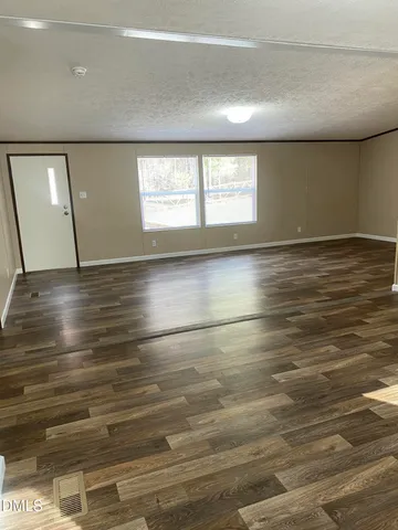 a kitchen with a sink a potted plant and a window