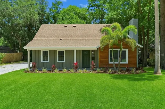 a front view of house with a garden and porch