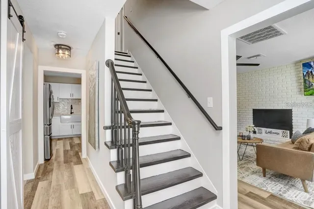 a view of entryway and hall with wooden floor