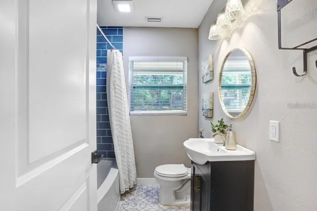 a bathroom with a sink toilet and a mirror