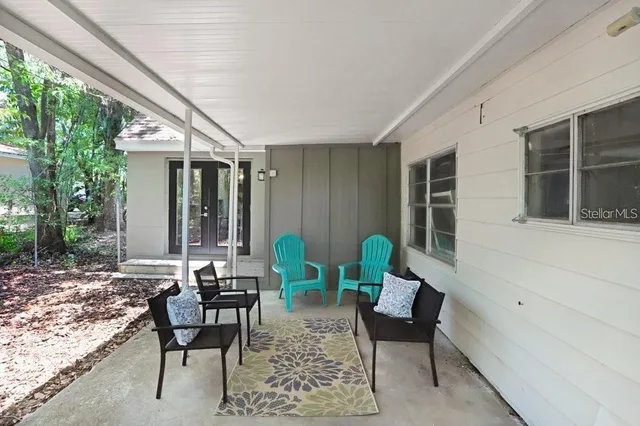 a view of a house with backyard and sitting area