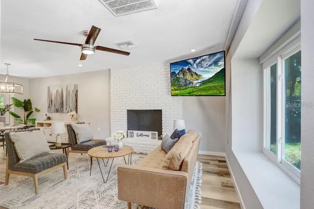 a living room with furniture a flat screen tv and a fireplace