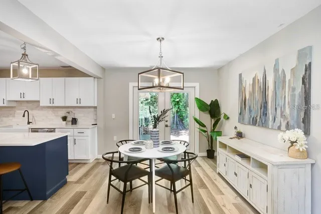 a kitchen with a table chairs stove and cabinets