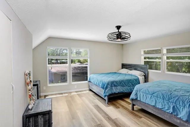 a bedroom with two beds and a window