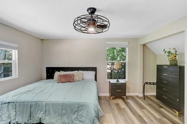 a bedroom with a bed and a window