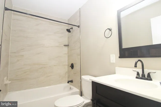 a bathroom with a sink mirror toilet and bathtub