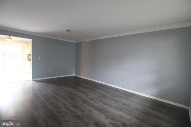 a view of an empty room and wooden floor
