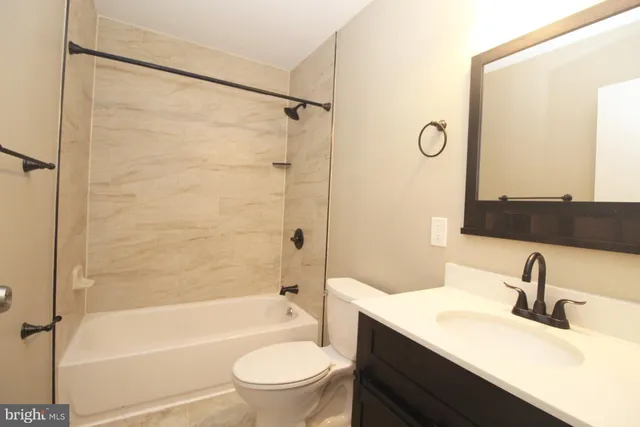 a bathroom with a sink toilet tub and shower