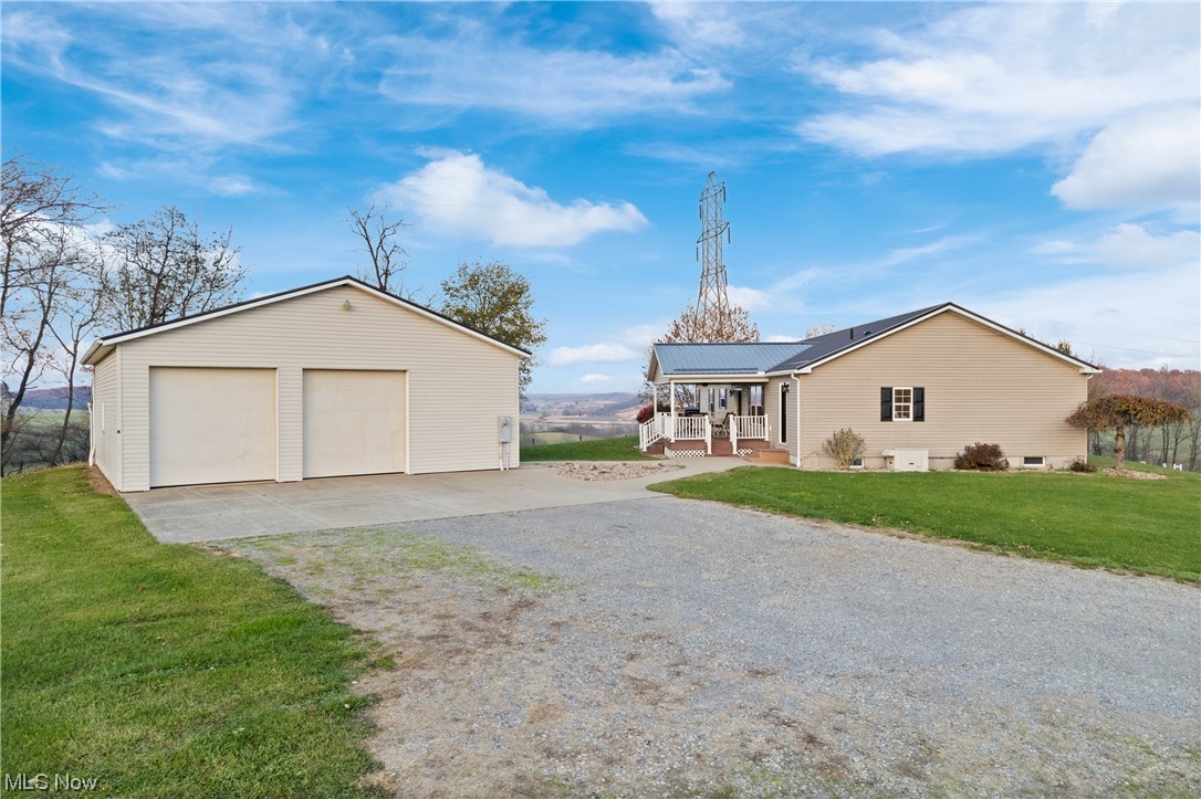 View of front of house featuring a front yard and a garage