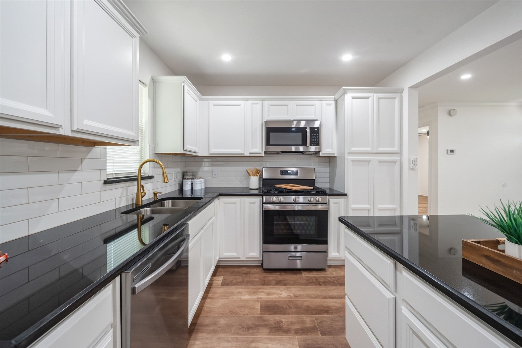 3051 Rothermel Road Houston, TX 77093 - Photo 8 of 24 Sleek gas range and built-in microwave for a seamless kitchen experience.