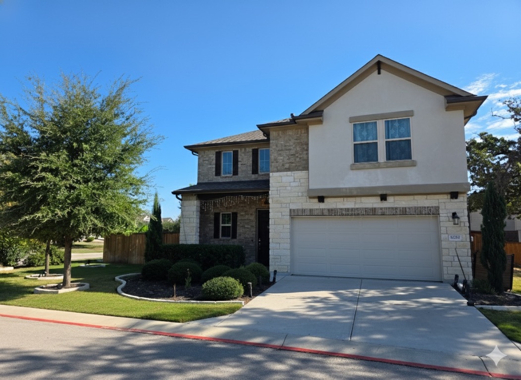 a front view of a house with a yard and garage