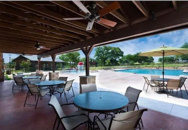 a view of a patio with a table chairs and a backyard
