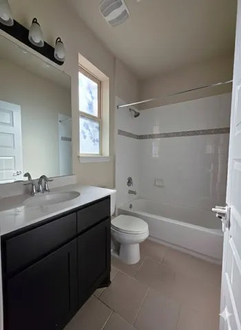a bathroom with a double vanity sink toilet and shower