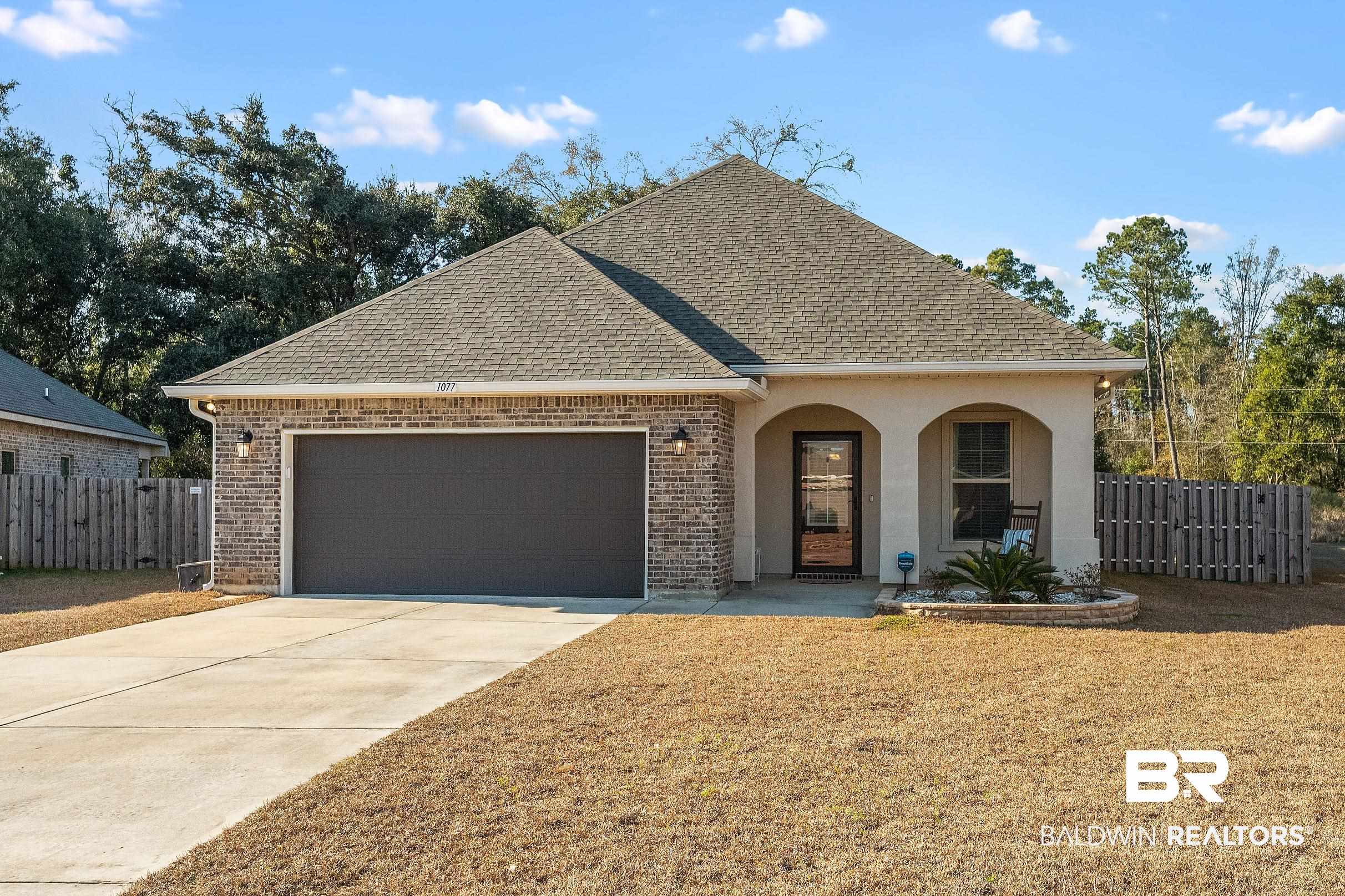 1077 Stella Road Foley, AL 36535 - Photo 26 of 27 View of front facade featuring brick siding, a shingled roof, a garage, and concrete driveway