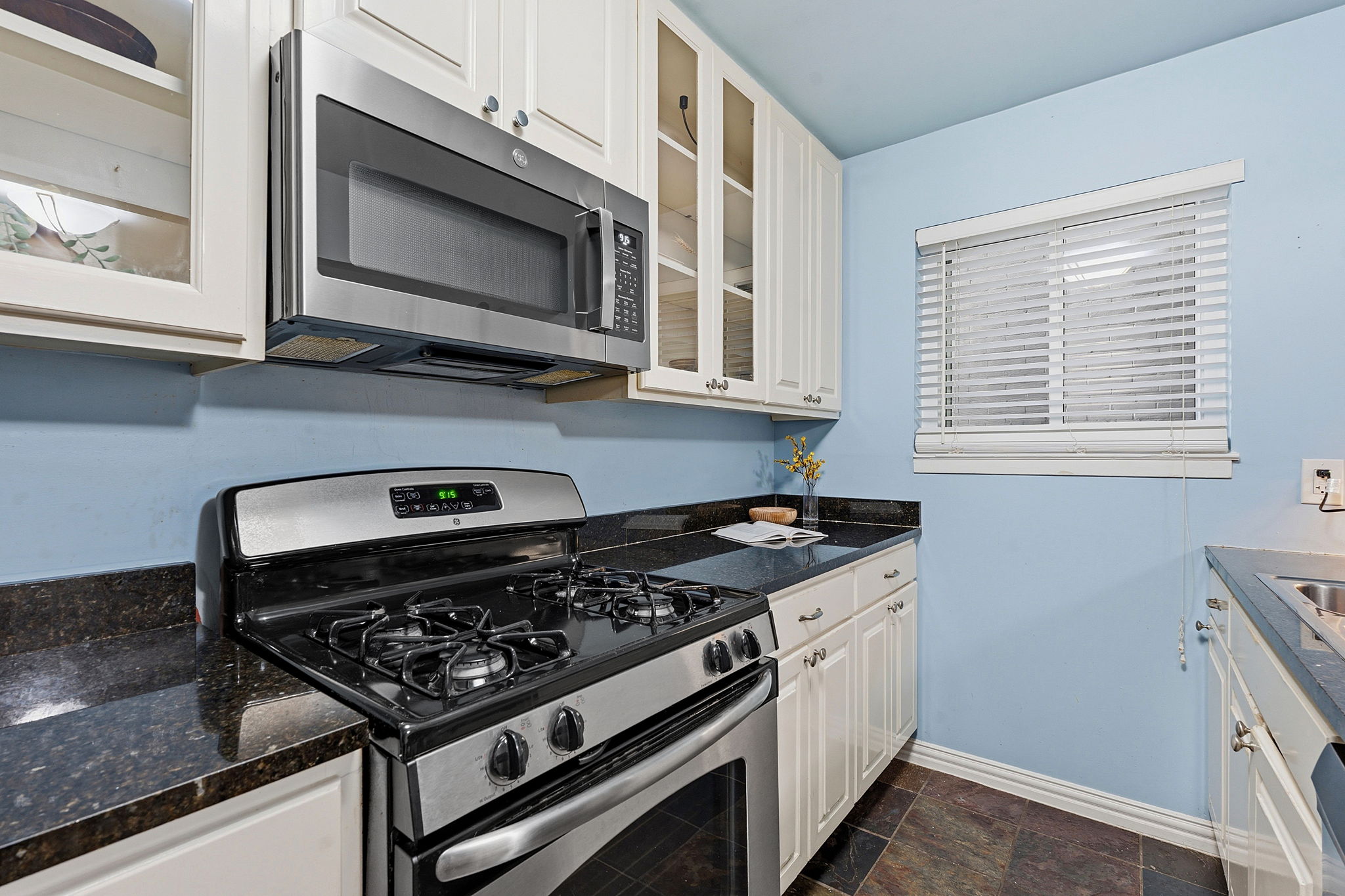 1210 Windsor Road, Unit 104 Austin, TX 78703 - Photo 11 of 29 A compact kitchen with sleek appliances and ample counter space for culinary endeavors.