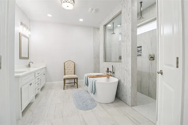a spacious bathroom with a double vanity sink a mirror and a bathtub