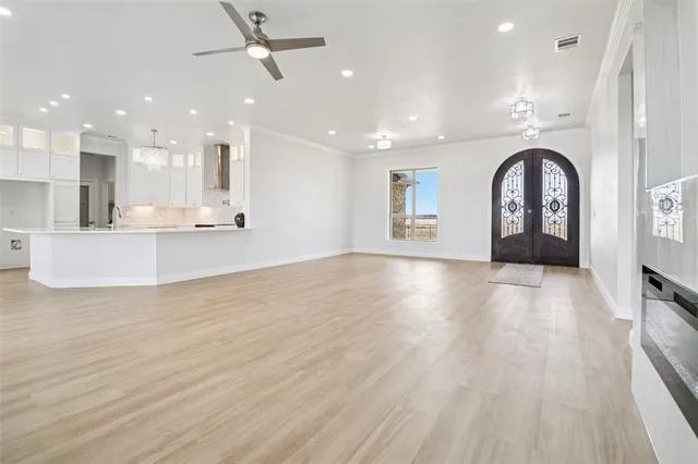 a view of a big room with wooden floor and a window