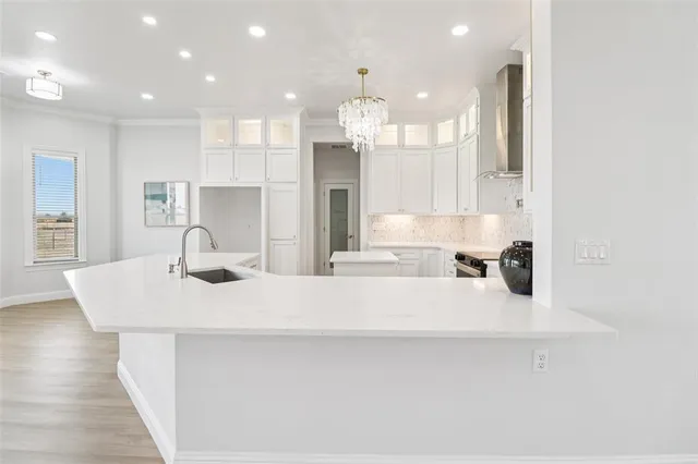 a large kitchen with kitchen island a sink appliances and a counter top space
