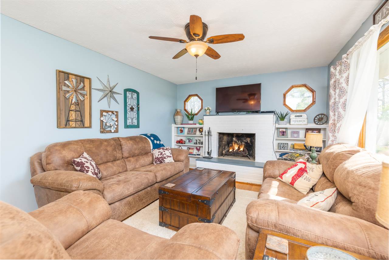 275 Swoope Road Swoope, VA 24479 - Photo 14 of 41 a living room with furniture a clock and a fireplace