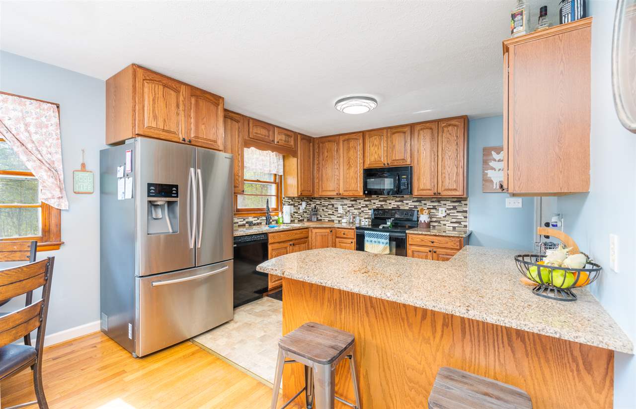 275 Swoope Road Swoope, VA 24479 - Photo 19 of 41 a kitchen with stainless steel appliances granite countertop a refrigerator a stove a sink cabinets and a dining table