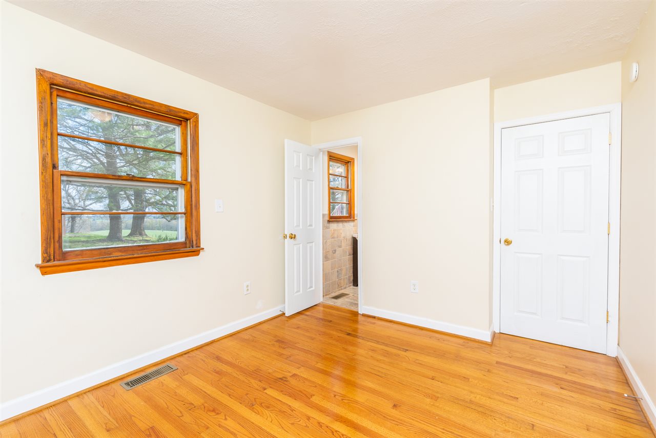 275 Swoope Road Swoope, VA 24479 - Photo 30 of 41 a view of an empty room with wooden floor and a window