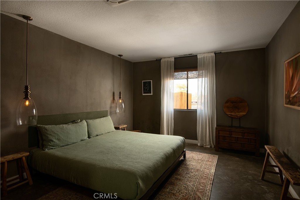 382 Cherokee Trail Yucca Valley, CA 92284 - Photo 12 of 33 a bedroom with a bed and a window