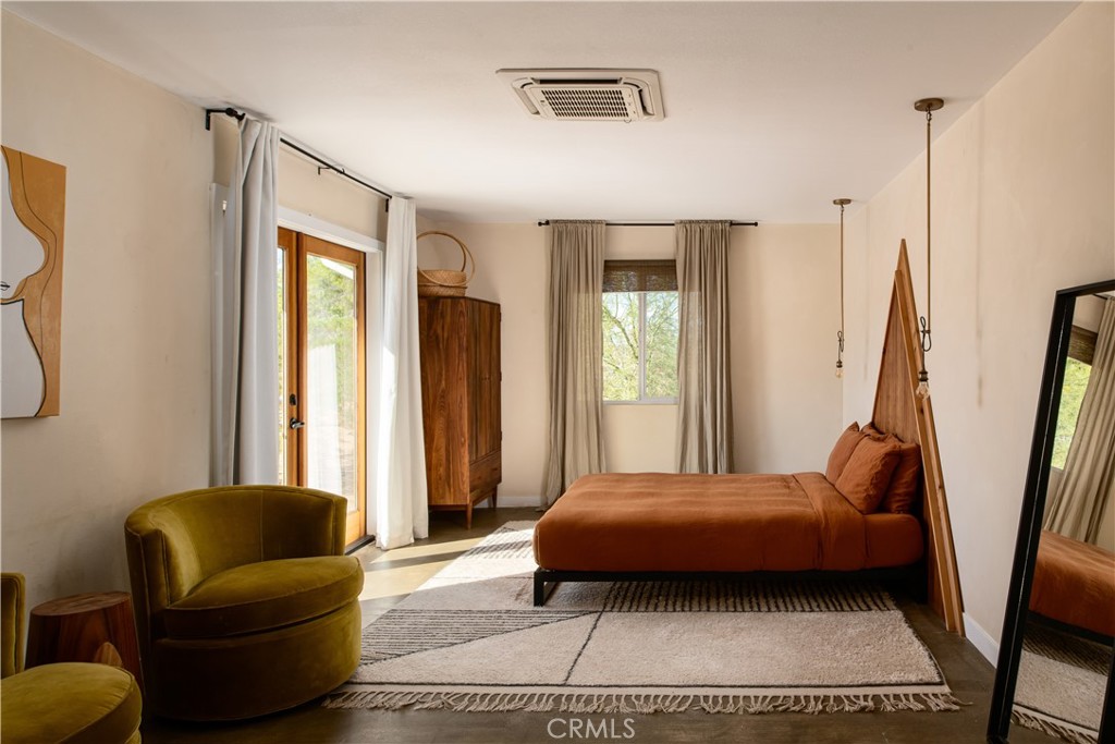 382 Cherokee Trail Yucca Valley, CA 92284 - Photo 15 of 33 a bedroom with a bed and a couch