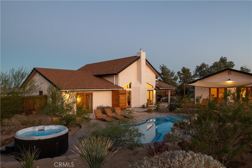 382 Cherokee Trail Yucca Valley, CA 92284 - Photo 2 of 33 a view of a patio with table and chairs under an umbrella