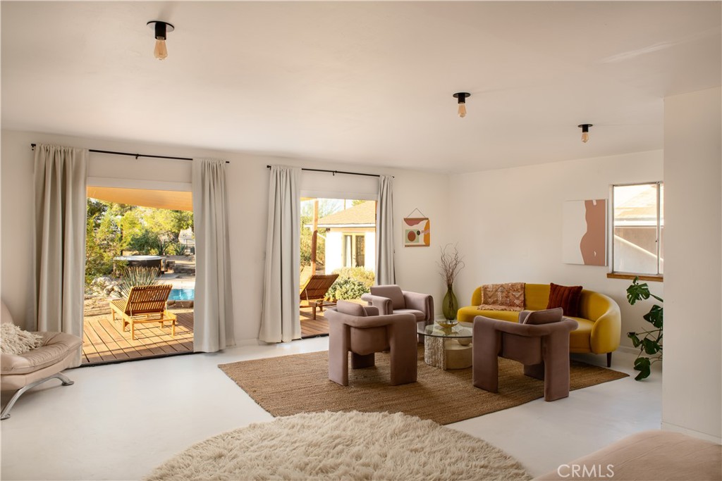 382 Cherokee Trail Yucca Valley, CA 92284 - Photo 21 of 33 a living room with furniture and large windows