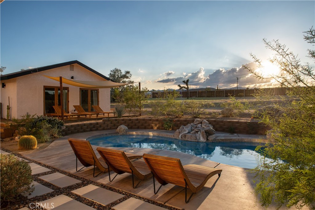 382 Cherokee Trail Yucca Valley, CA 92284 - Photo 27 of 33 a view of a swimming pool with lounge chairs