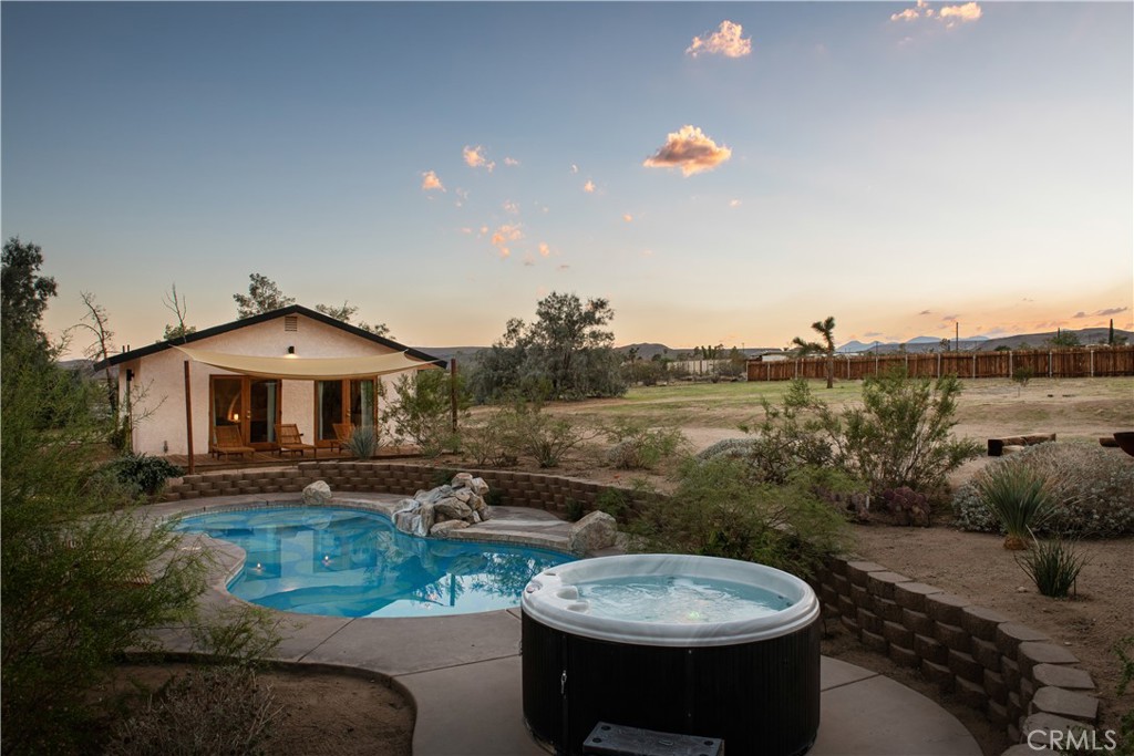 382 Cherokee Trail Yucca Valley, CA 92284 - Photo 28 of 33 a view of a swimming pool with a patio and a garden