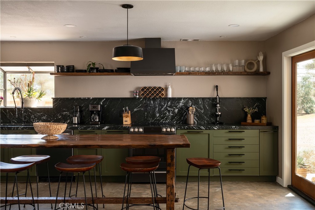 382 Cherokee Trail Yucca Valley, CA 92284 - Photo 5 of 33 a kitchen with stainless steel appliances granite countertop a sink and a stove
