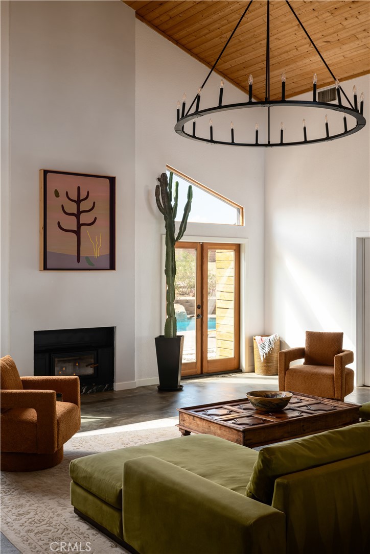 382 Cherokee Trail Yucca Valley, CA 92284 - Photo 8 of 33 a bedroom with furniture and a fireplace