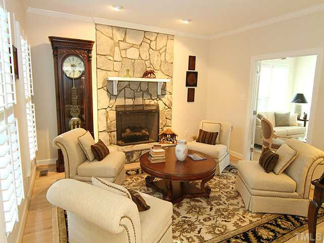 A stone faced fireplace with gas logs is a focal point in the living room. Walk through the french doors to the family/sun room with shelves and windows galore. Living Room