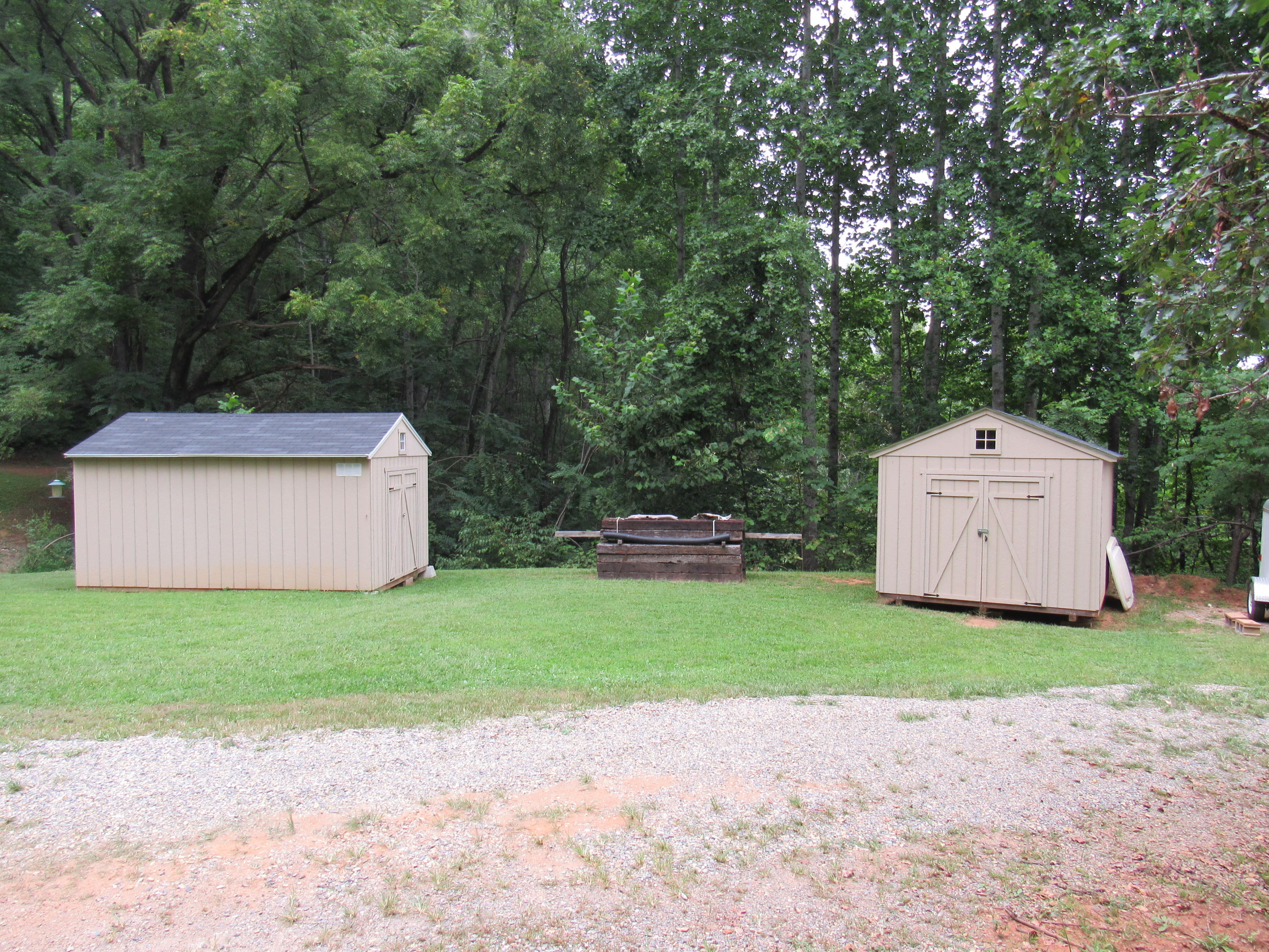 2700 Johnny's Ridge Road Ferrum, VA 24088 - Photo 27 of 32 a view of a back yard with a house and large trees with wooden fence