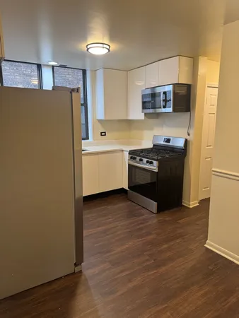 a kitchen with a refrigerator and a stove