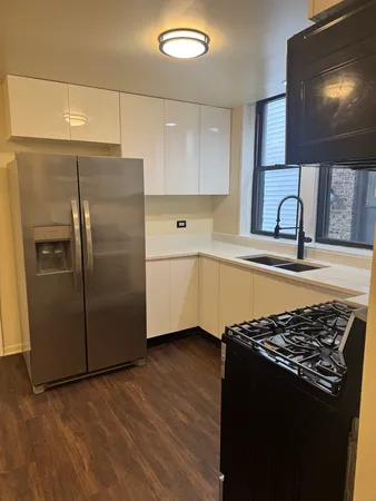 a kitchen with stainless steel appliances granite countertop a refrigerator and a sink